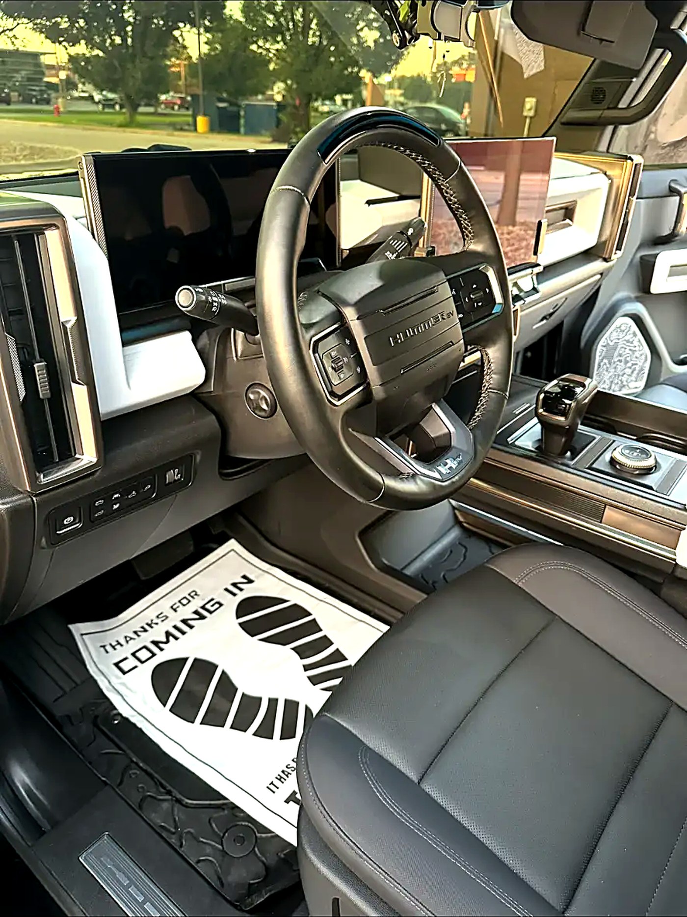 GMC Hummer EV cockpit detailed with a protective floor sheet in place
