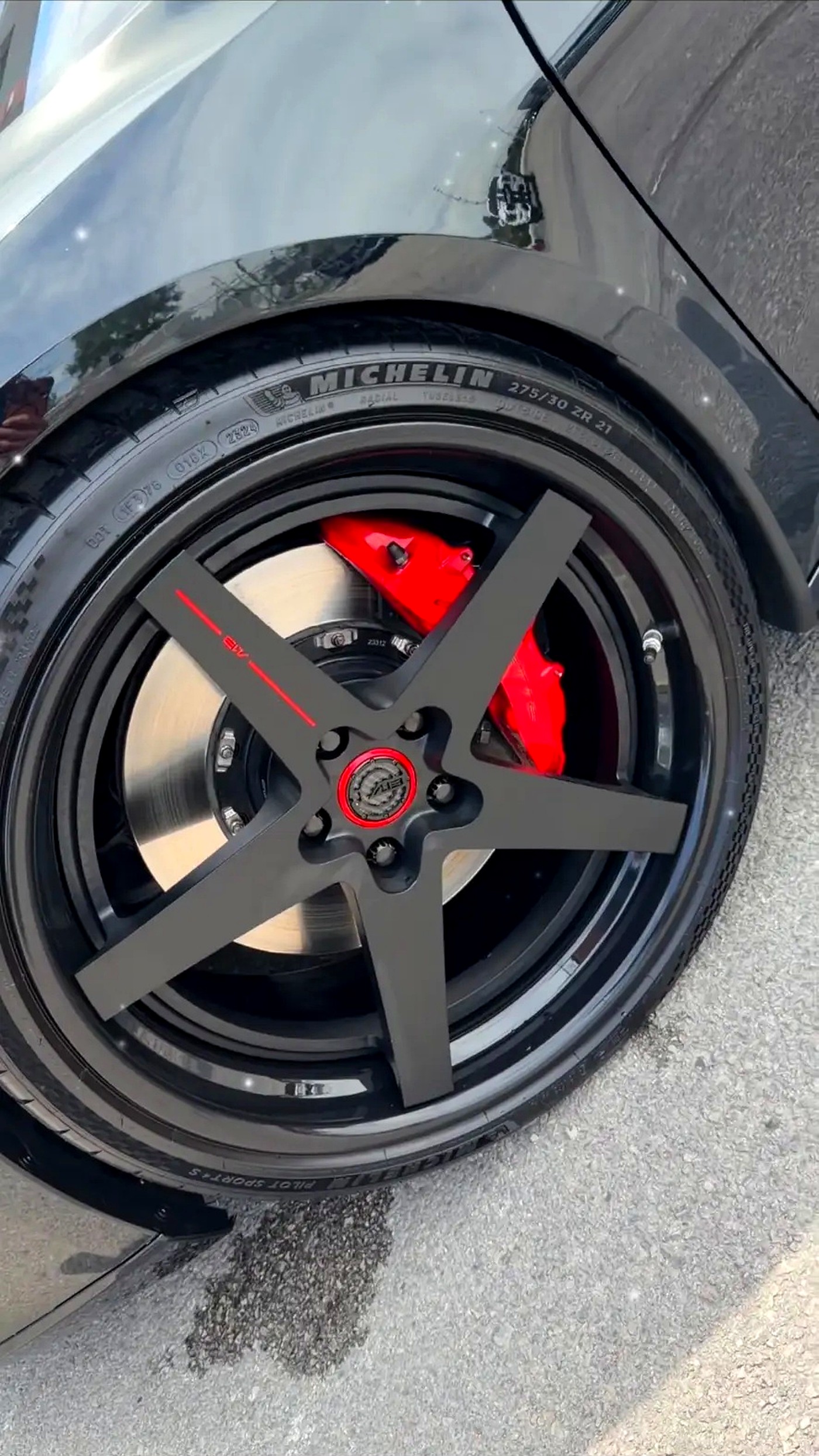 Black performance wheel with red brake calipers