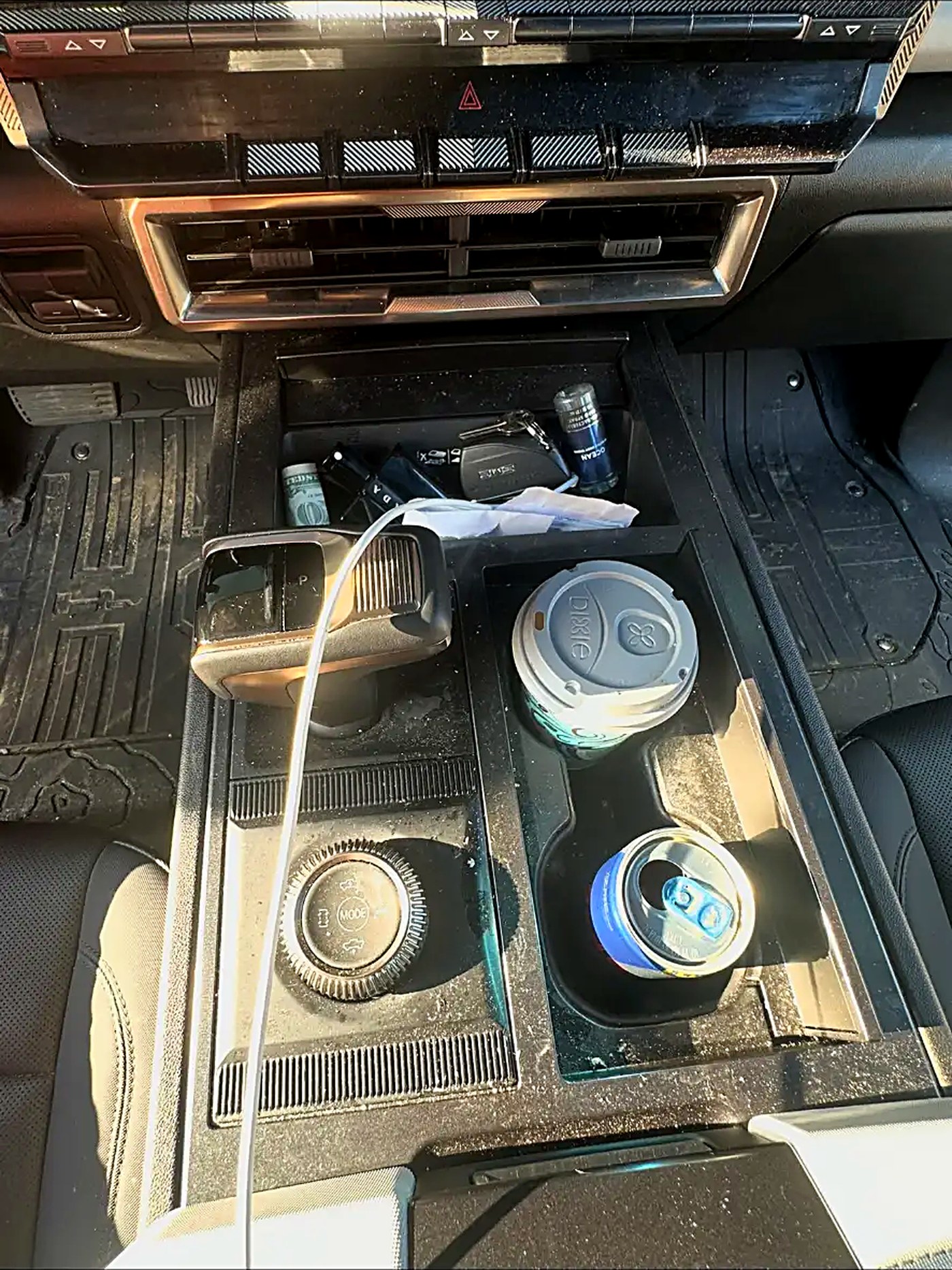 Dusty center console and cup holders before an interior detail