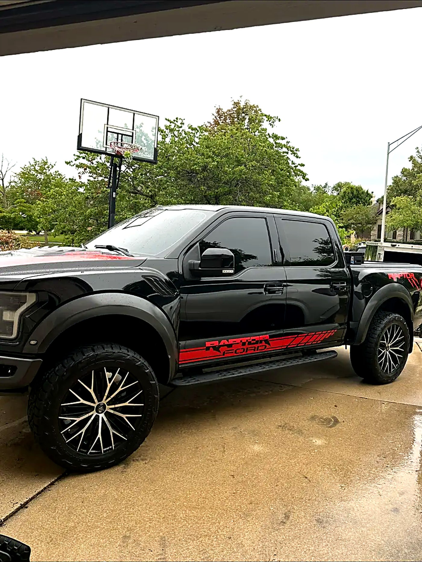 Black Ford F-150 Raptor washed and gleaming on a driveway